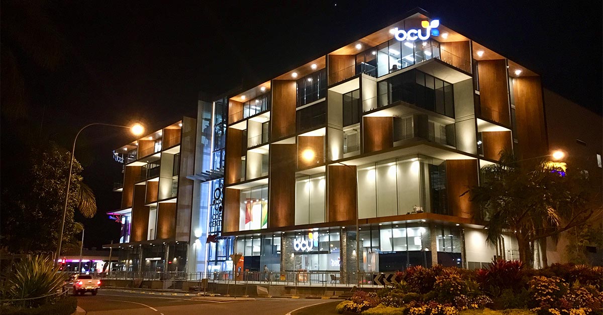 Night time image of the bcu Coffs Central building, lit up